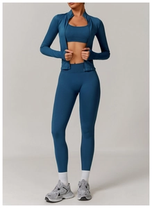 Three-piece dark blue seamless yoga set with jacket, sports bra, and high-waisted leggings