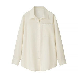 Detail of cream corduroy shirt featuring lace embroidery on pocket and cuffs