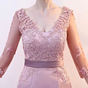 Close-up of V-neck evening gown with floral lace embroidery and delicate beadwork