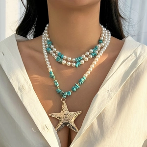 Bohemian layered necklace with faux pearls, turquoise stones, and large gold starfish pendant