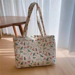 Detailed macro of the quilted cotton tote bag with colorful vintage puppy prints