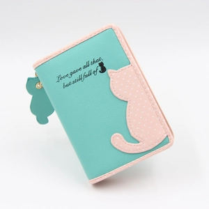 Close-up of cute cartoon cat purse with teal PU leather and pink polka dot details