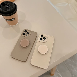 Detail of khaki and beige iPhone cases with integrated round retractable stands