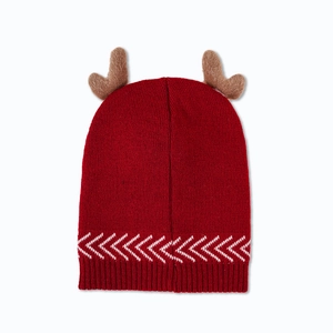 Close-up of red Christmas knit hat featuring 3D brown antlers and white wave patterns