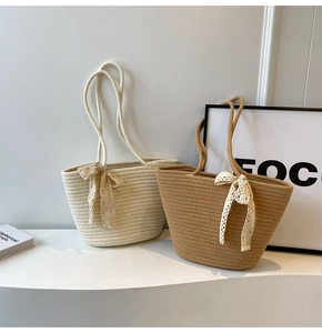 Close-up of hand-woven tote bags with lace bow accents in cream and camel shades