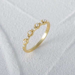 Macro shot of S925 silver gold-plated ring showing pearls and cubic zirconia details