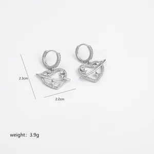 Detailed view of silver heart and saturn earrings with rhinestones measuring 2.3cm