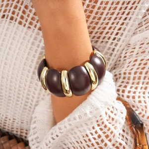 Close-up of retro acrylic round beads and gold metal spacers on woman's wrist