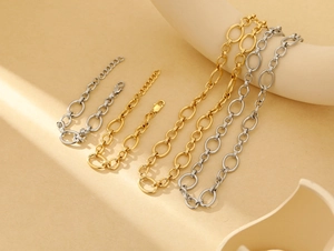 Detailed shot of gold and silver chunky oval link bracelets with lobster clasp closures