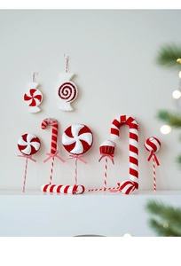 Detail of glittery candy cane and lollipop ornaments with festive red and white stripes