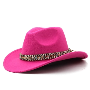 Detail of rose red cowboy hat featuring an ethnic woven band and textured felt material