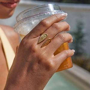 Close-up of golden angel wing adjustable ring in 18K gold plated stainless steel
