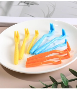 9-piece pet tick remover set in three colors and sizes displayed on a ceramic tray