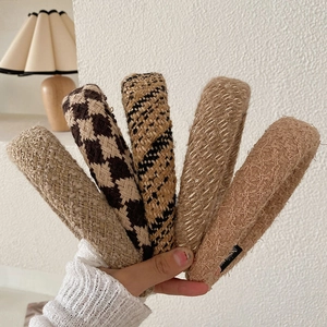 Set of five stylish knitted plaid headbands in beige and brown for a vintage winter look