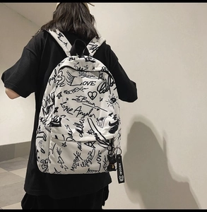 Detail of white backpack with black hand-drawn graffiti and Love Los Angeles print