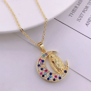Close-up of golden Virgin Mary crescent moon pendant with multi-color zircon stones