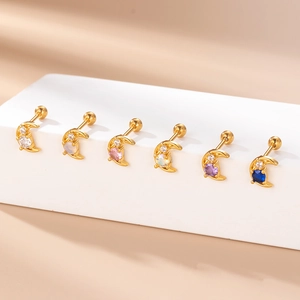 Set of 6 gold moon screw-back earrings with colorful zircon stones on a white stand