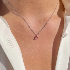 Close-up of elegant pink heart zircon pendant on an 18k gold plated chain