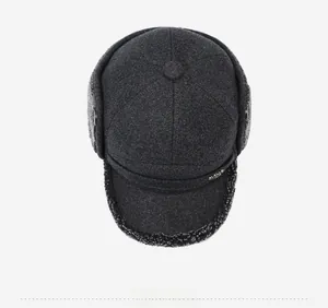 Top view of a thick dark grey winter trapper hat with warm faux lamb wool lining