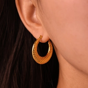 U-shaped checkered gold hoop earrings featuring a 18k gold plated textured finish