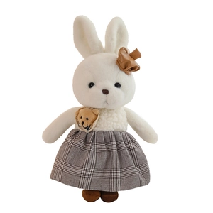 Cute white plush rabbit toy in grey checkered dress with a bow for wedding decor
