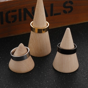 Polished 6mm stainless steel rings in gold, silver, and black on wooden display stands