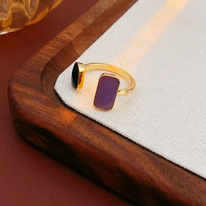 Detail of gold open ring with geometric purple and black enamel drip oil elements