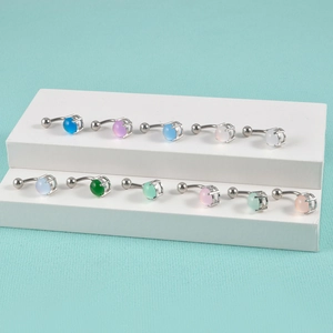 14G stainless steel belly button ring featuring colorful cat eye stones on a white stand