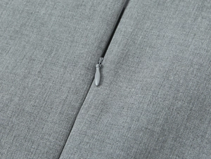Macro detail of high-quality invisible zipper on gray satin textured fabric with fine twill