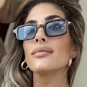 Retro square tortoiseshell sunglasses with light blue lenses and metal rivets on model