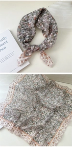 Detail of floral cotton linen scarf showing butterfly patterns and sheer fabric texture