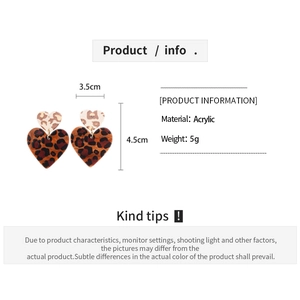 Detail view of heart-shaped leopard print acrylic earrings with dimensions and weight