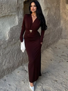 Detail of burgundy deep V-neck maxi dress featuring pleated waist and golden buckle