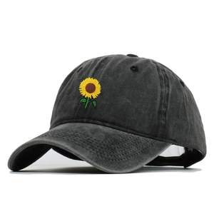 Vintage washed grey cotton baseball cap with embroidered sunflower on white background