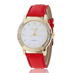 Detail of a ladies' quartz watch with a red leather strap and sparkling rhinestone bezel
