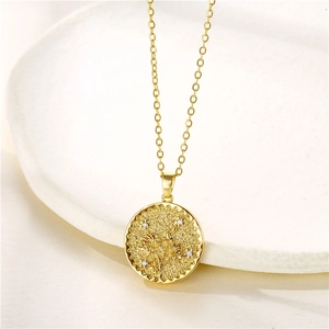Close-up of golden coin necklace with floral relief and small zircon stones on display