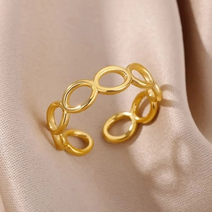 Detail shot of a 18k gold plated stainless steel hollow flower ring on pink silk