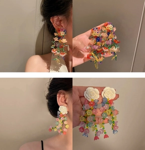 Detail showing colorful beaded flower cluster and white rose tassel drop earrings