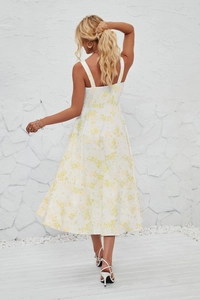 Detail of French style floral sun dress with wide straps and side slit on white back