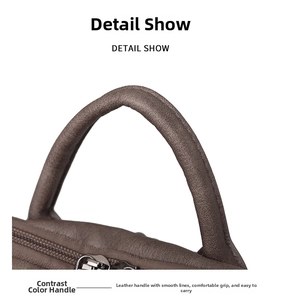 Detail show of contrast color handle and metal zipper on brown leather backpack