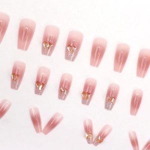 Pink gradient coffin press-on nails with amber heart rhinestone and silver glitter accents