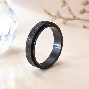 Matte black titanium steel rotating ring with textured finish for stress relief