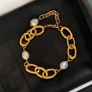 Detailed macro of 18k gold plated chain bracelet with three baroque freshwater pearls