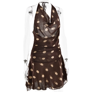 Detail view of brown polka dot halter dress with draped neckline and ruched waist