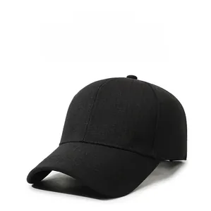 Detail shot of black textured baseball cap featuring a golden metal letter logo