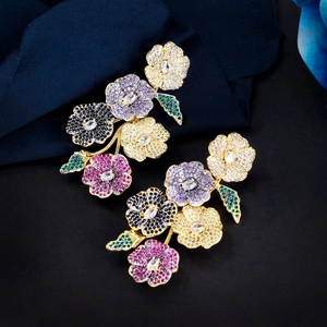 Macro detail of floral drop earrings with vibrant multi-color zircon pavé setting