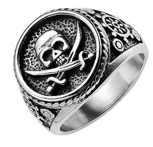 Macro detail of vintage pirate skull ring with cross swords and side rudder carvings