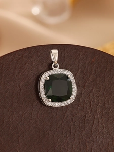 Close-up of square emerald green gemstone pendant with double halo of micro-pave diamonds