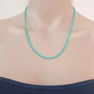 Minimalist turquoise box chain necklace in stainless steel shown on a mannequin model