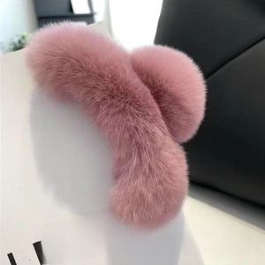 Detail view of the soft pink plush shark hair claw clip with a fuzzy texture for women